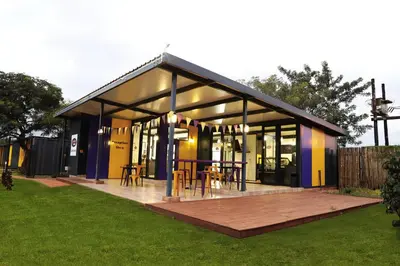 a building with tables and chairs in a yard at SleepOver Komatipoort in Komatipoort