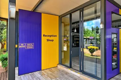 an office building with purple and yellow doors at SleepOver Komatipoort in Komatipoort