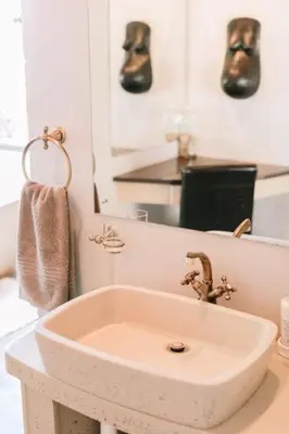a bathroom with a sink and a mirror at Tshukudiba Game Lodge in Tom Burke