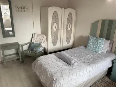 a bedroom with a bed with surfboards on the wall at Le Soleil in Graskop