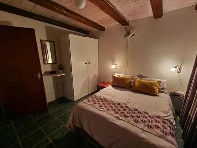 a bedroom with a large bed in a room at Carpe Diem in Marloth Park