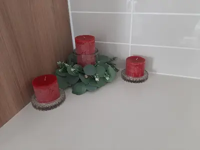 three red candles sitting next to a plant in a bathroom at The Blyde Crystal Lagoon penthouse in Pretoria