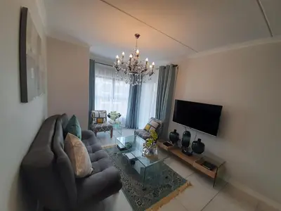 a living room with a couch and a table at The Blyde Crystal Lagoon penthouse in Pretoria