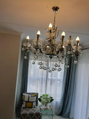 a chandelier in front of a window at The Blyde Crystal Lagoon penthouse in Pretoria
