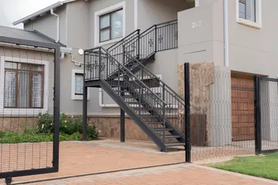a metal staircase on the side of a building at Ruebys Apartment 202 in Dullstroom