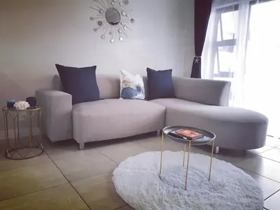 a living room with a couch and a table at The Blyde in Pretoria