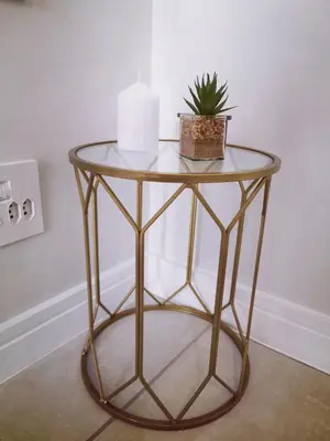 a gold side table with a plant on it at The Blyde in Pretoria