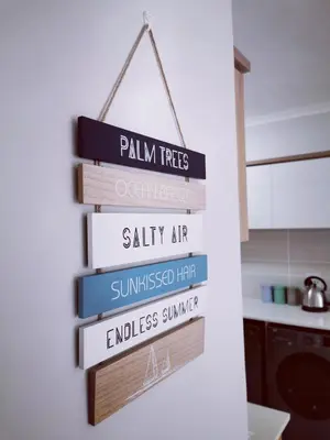 a stack of books hanging on a wall in a kitchen at The Blyde in Pretoria