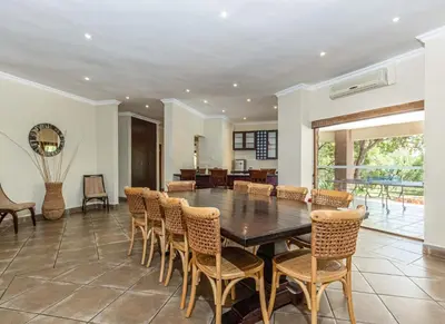 a dining room with a table and chairs at Elements Bush Villa 216 in Moheme