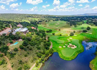 an aerial view of the golf course at the inn on the river at Elements Bush Villa 216 in Moheme
