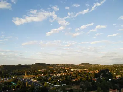 a view of a city with a blue sky and clouds at The Residence Studio - Menlyn Maine in Pretoria