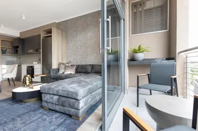 a living room with a couch and a table at Menlyn Apartment in Pretoria