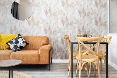 a living room with a couch and a table and a mirror at Menlyn Apartment in Pretoria