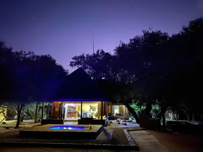 a house at night with the lights on at Twiga Lodge Mabalingwe in Bela-Bela