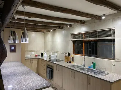 a large kitchen with a sink and a counter at Twiga Lodge Mabalingwe in Bela-Bela