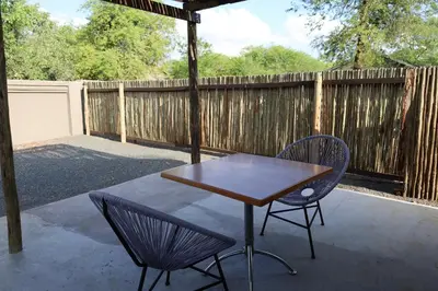 a table and two chairs on a patio at Together Lifestyle Resort in Malamulele