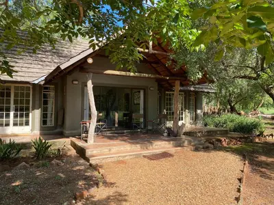 a house with a porch and a patio at Murchison View Cottage in Gravelotte