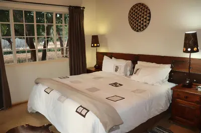 a bedroom with a large bed and a window at Murchison View Cottage in Gravelotte
