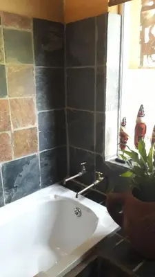 a bathroom with a white sink and a mirror at Canyon guest villa in Hoedspruit