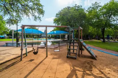 a playground with a slide in a park at ATKV Eiland Spa in Letsitele
