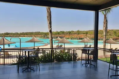 a view of the pool at a resort with tables and chairs at The Blyde Crystal Lagoon in Pretoria