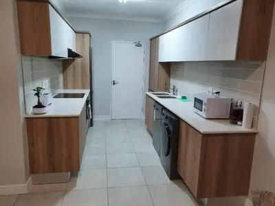 a kitchen with a sink and a microwave at The Blyde Crystal Lagoon in Pretoria