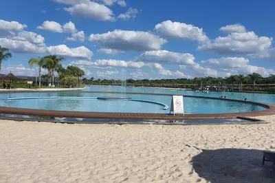 a large swimming pool on a beach next to the sand at The Blyde Crystal Lagoon in Pretoria