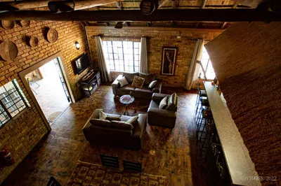an overhead view of a living room with couches and chairs at Adventure Bush House in Marloth Park