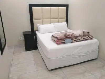 a white bed with a black and white headboard in a room at Classic-Lodge in Kempton Park