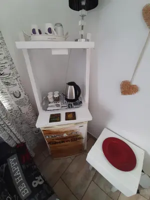 a small kitchen with a stove and a shelf at MyKhaya-your home away from home in Kempton Park