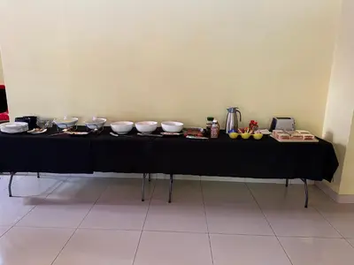 a black table with bowls and plates on it at Tertius Lodge And House in Nelspruit