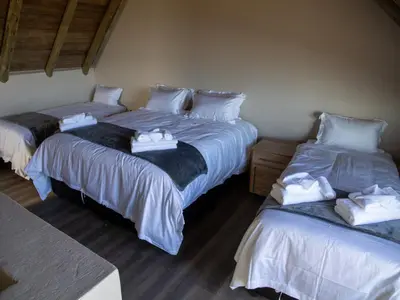 a room with two beds with towels on them at Hillside lodge in Moheme