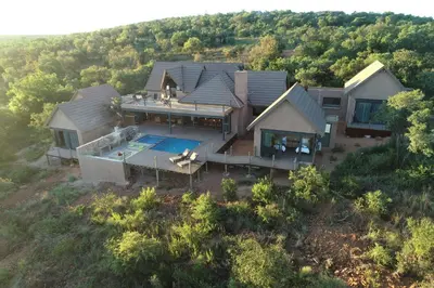 an aerial view of a house with a swimming pool at Hillside lodge in Moheme