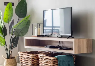 a tv on a wooden shelf with a mirror at The Blyde - Appartement De Luxe in Pretoria