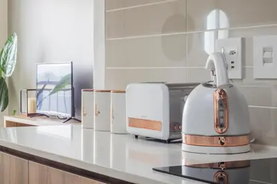 a white appliance sitting on a counter in a kitchen at The Blyde - Appartement De Luxe in Pretoria