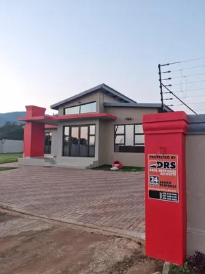 a red post box in front of a house at ONNIE GUESTHOUSE in Louis Trichardt
