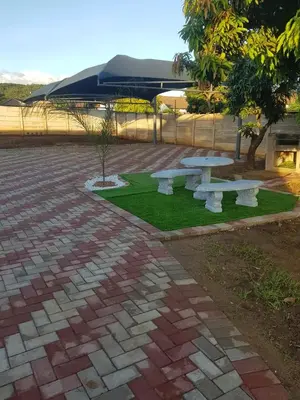 a group of picnic tables in a park at ONNIE GUESTHOUSE in Louis Trichardt