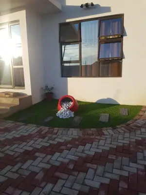 a house with a red frisbee in a yard at ONNIE GUESTHOUSE in Louis Trichardt