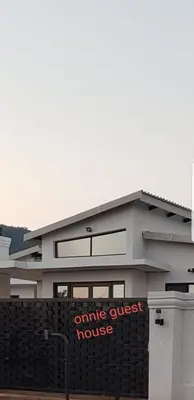 a building with an online guest house sign on it at ONNIE GUESTHOUSE in Louis Trichardt