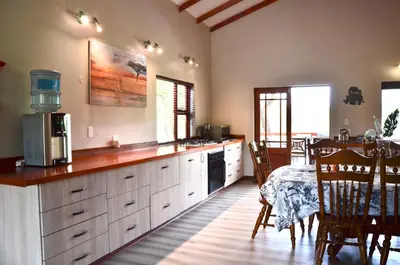 a large kitchen with a table and a dining room at Muqurati Lodge - Dinokeng Game Reserve in Klipdrift