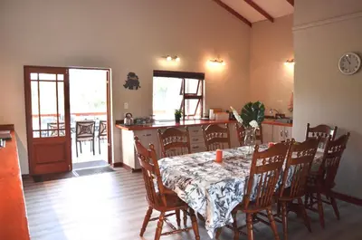 a kitchen and dining room with a table and chairs at Muqurati Lodge - Dinokeng Game Reserve in Klipdrift