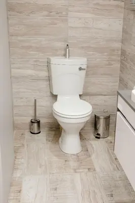 a bathroom with a white toilet in a room at Vinique Guesthouse in Nelspruit