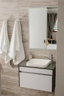 a bathroom with a sink and a mirror at Vinique Guesthouse in Nelspruit