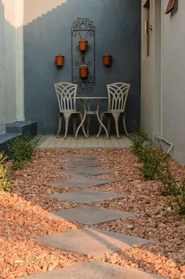 two chairs and a table on a patio at Vinique Guesthouse in Nelspruit