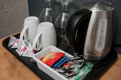 a tray with a toaster and packets of toothpaste at Vinique Guesthouse in Nelspruit