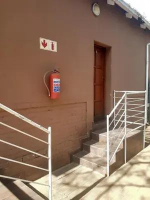 a fire hydrant on the side of a building with stairs at Hazelonz Bed &Breakfast in Pretoria