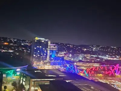a view of a city at night with lights at Menlyn Maine Luxury Apartments in Pretoria