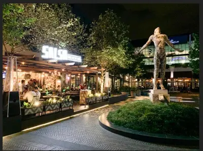 a statue of a man standing in front of a building at Menlyn Maine Luxury Apartments in Pretoria