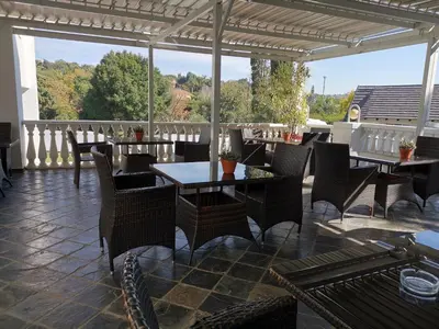 a restaurant with tables and chairs on a patio at Erasmus manor Guest House in Pretoria