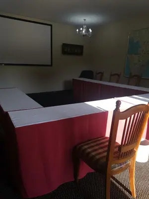 a red and white table with a chair and a screen at Erasmus manor Guest House in Pretoria